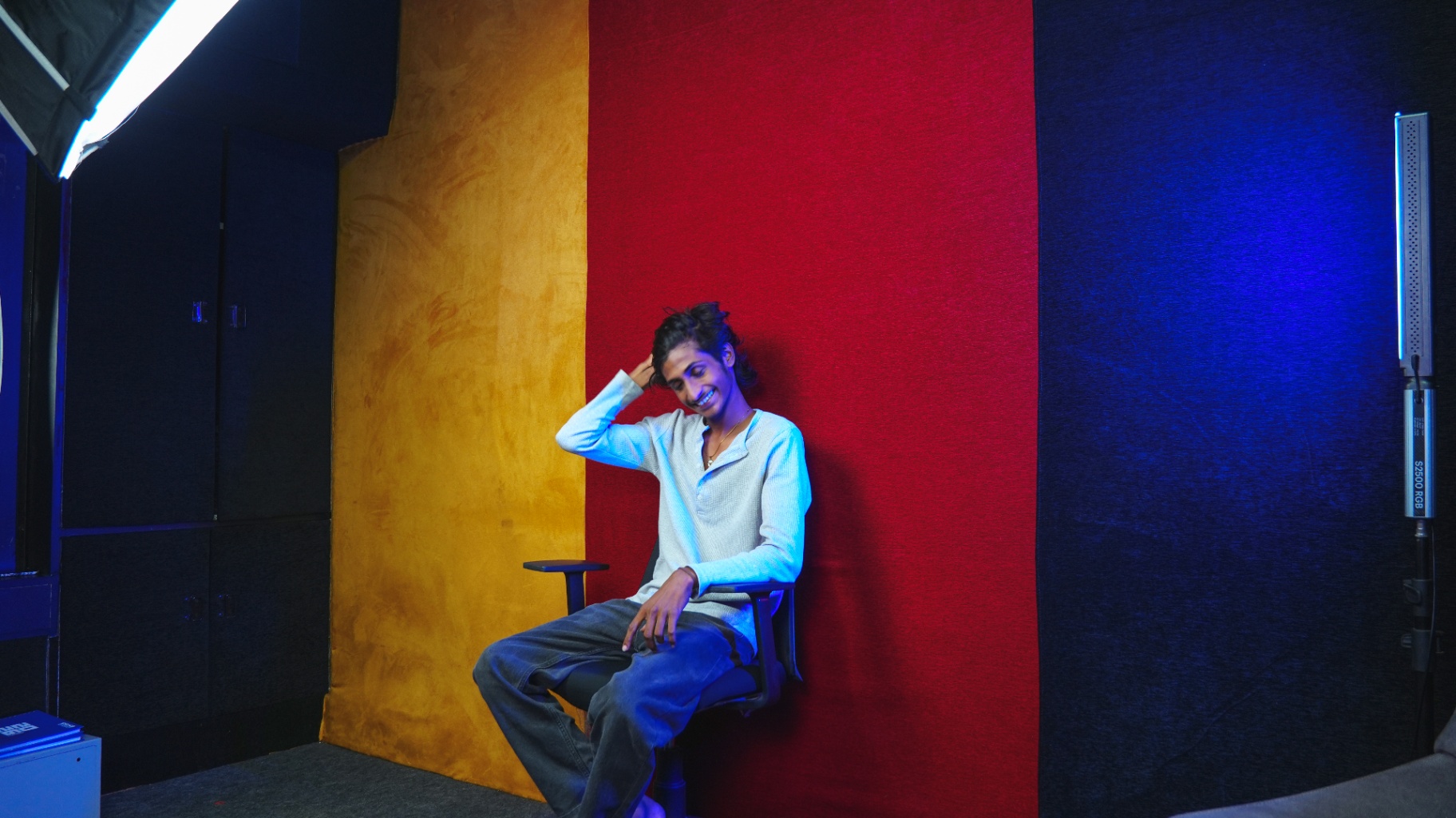 Studio corner with yellow, red and dark textured backdrop walls for portrait shoots
